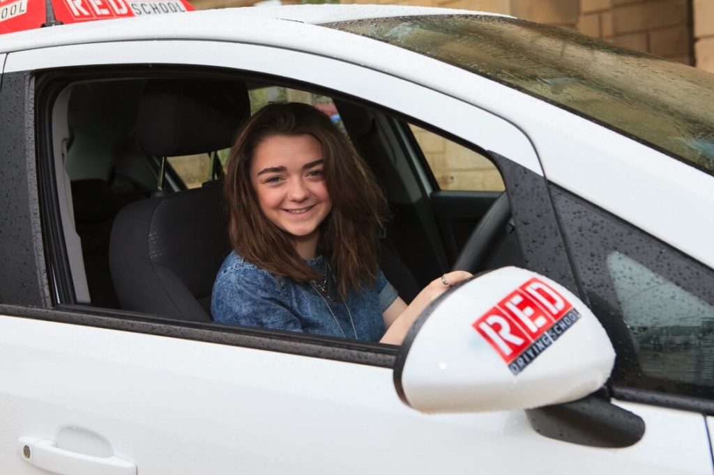 Maisie Williams in RED driving school car